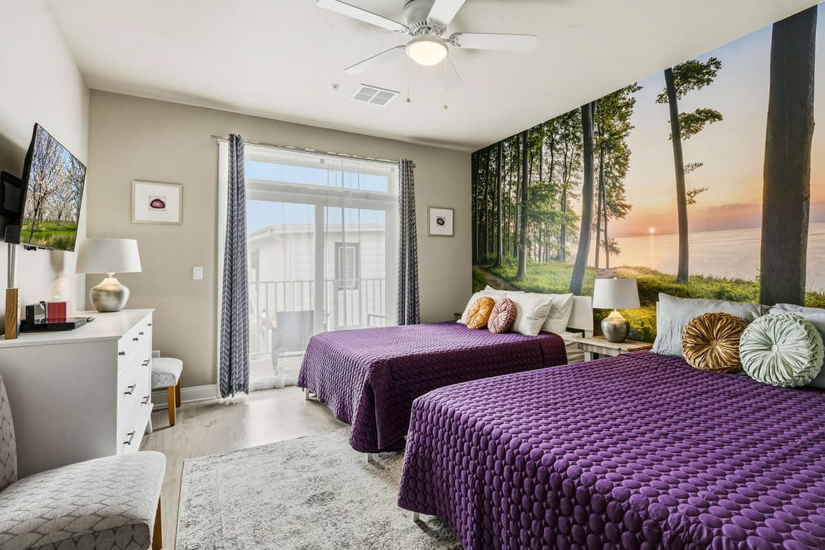 This spacious bedroom features two comfortable queen beds, making it a great choice for families or groups traveling together. The two-bed layout provides plenty of sleeping space while keeping everyone comfortably accommodated.