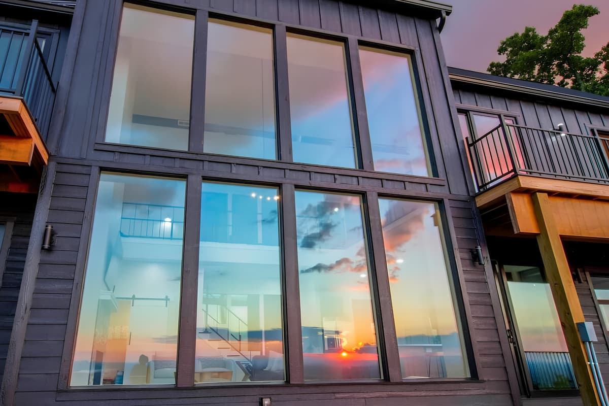 Large glass windows fill the home with natural light and showcase the beautiful surrounding views. Enjoy the scenery from the comfort of the indoors, with expansive windows creating a bright, open, and welcoming atmosphere throughout the space.