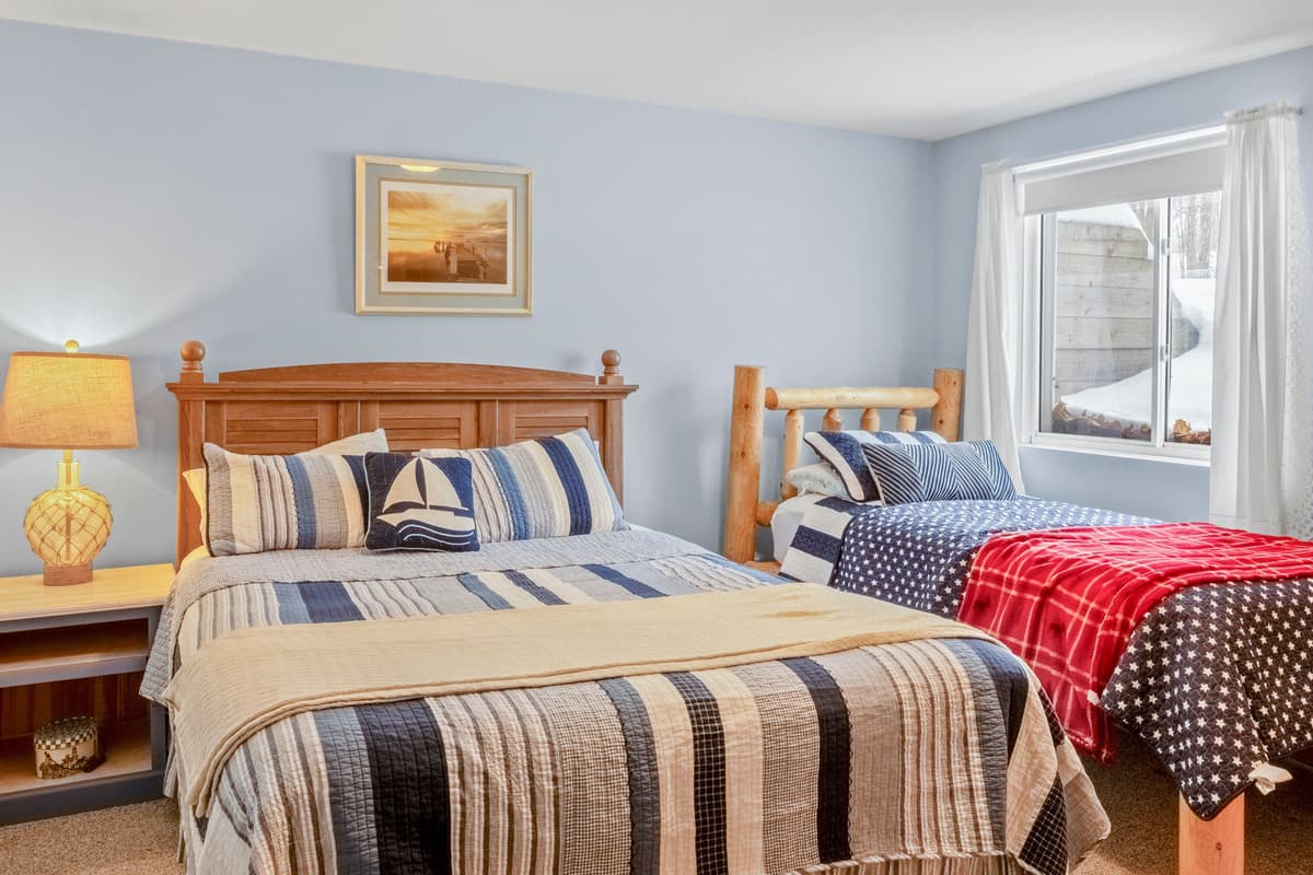 Just beyond the family room, you’ll find a comfortable bedroom configured with a queen bed and twin bed offering a quiet place to relax and recharge.