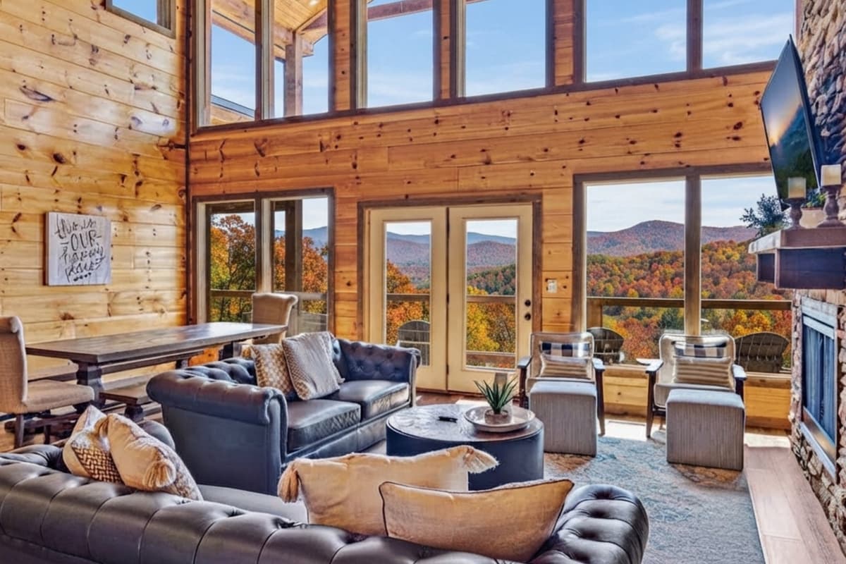 The living area features huge windows that bring the beauty of fall right indoors.