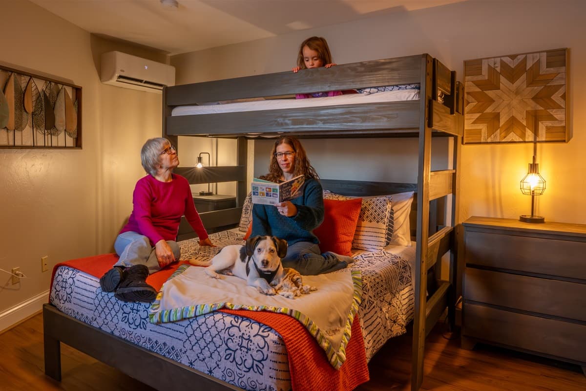 Cozy bedtime stories in our twin-over-queen bunk—sweet dreams start here!
