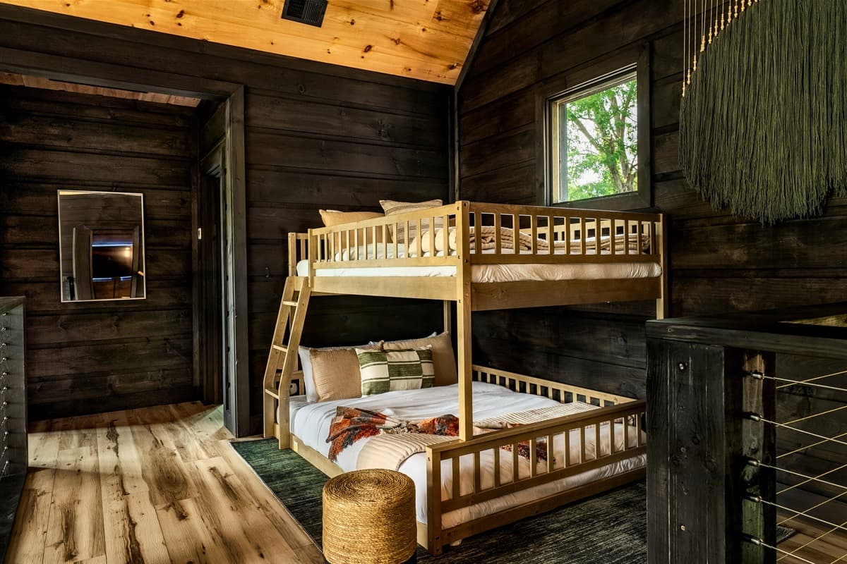This cozy bedroom features sturdy wooden bunk beds, perfect for accommodating multiple guests in comfort.