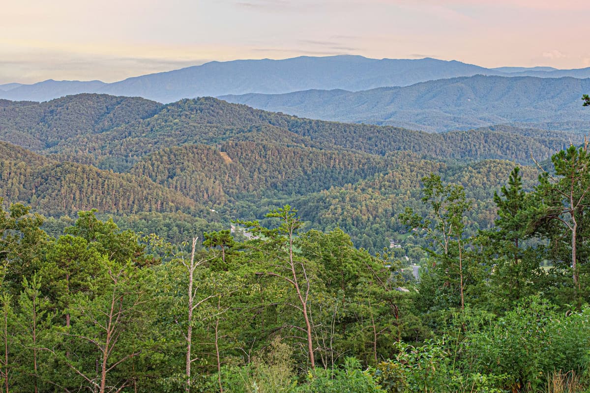 The surrounding landscape creates a peaceful backdrop for morning coffee, relaxing afternoons, and cozy evenings with loved ones