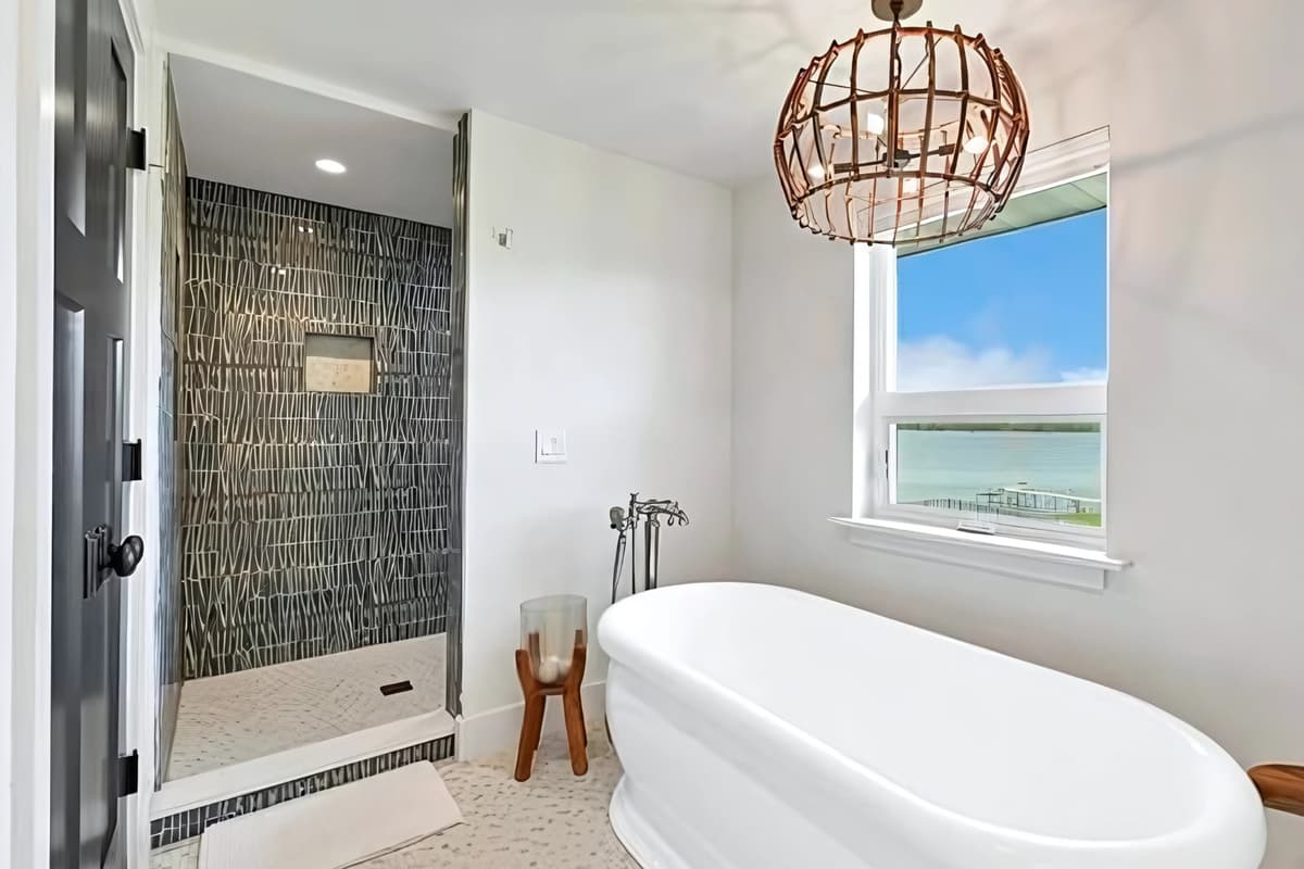 The combination of a freestanding tub and walk-in shower gives guests options for every part of their routine.