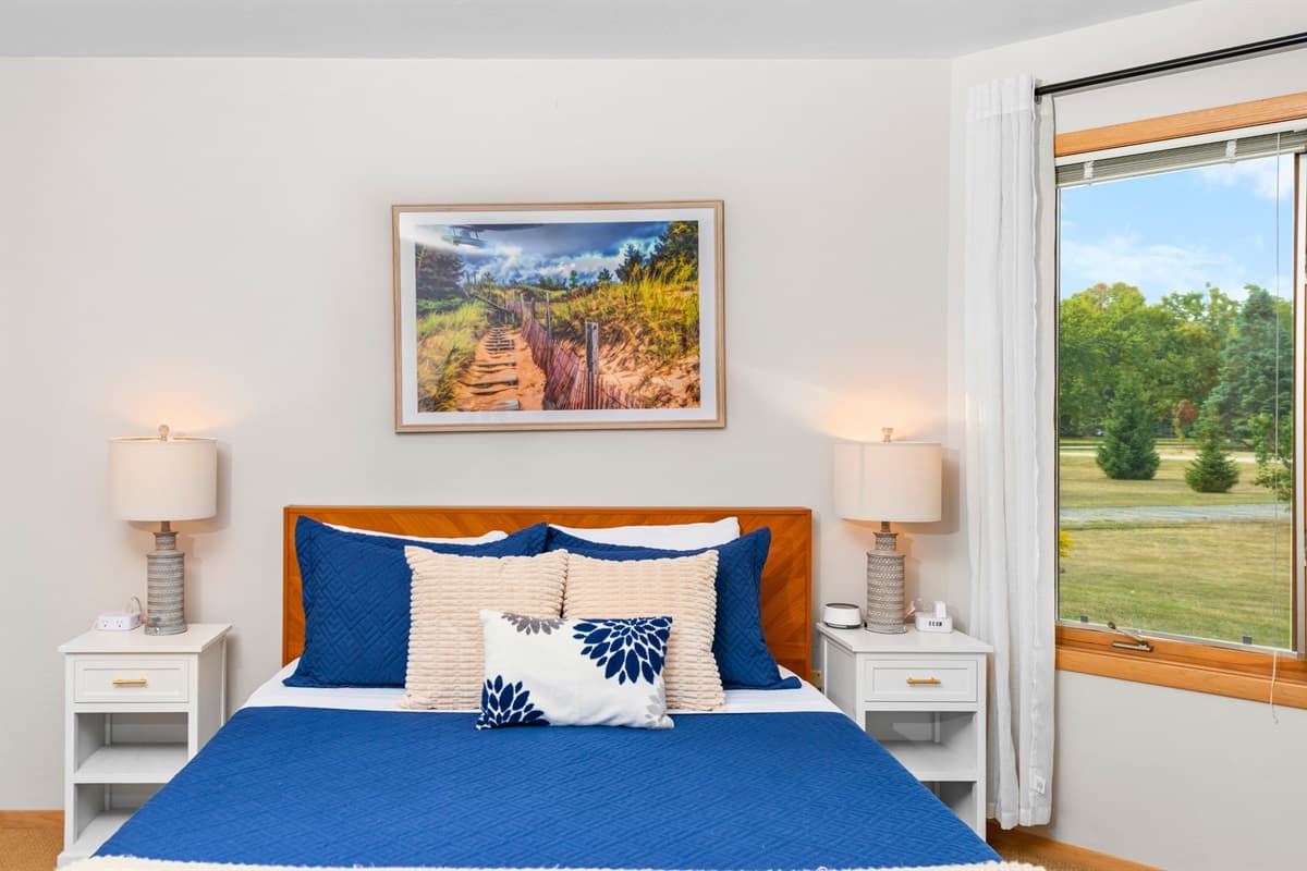This bedroom features a comfortable queen bed for a restful night’s sleep.