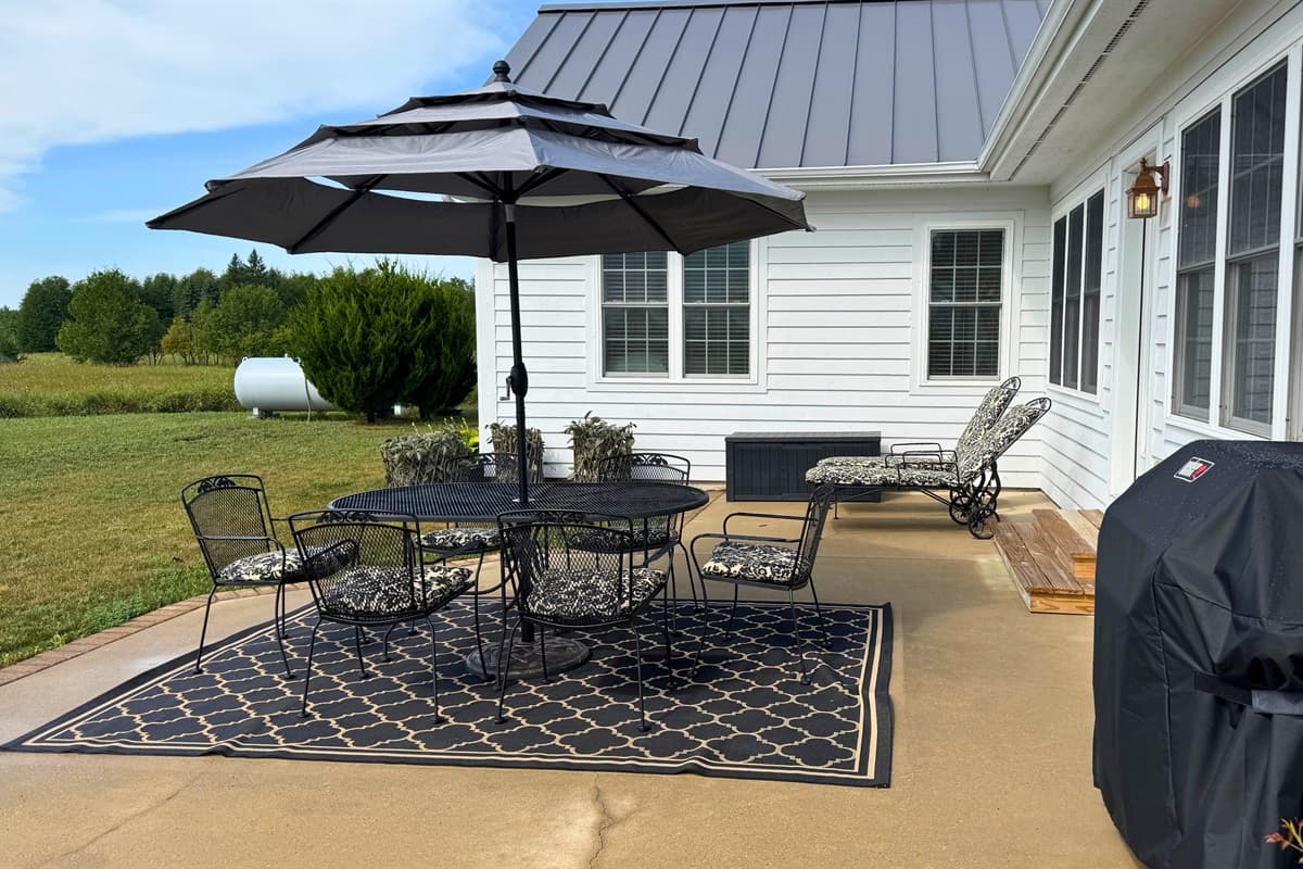 Outdoor dining seating with a shaded umbrella, perfect for enjoying meals in comfort. 