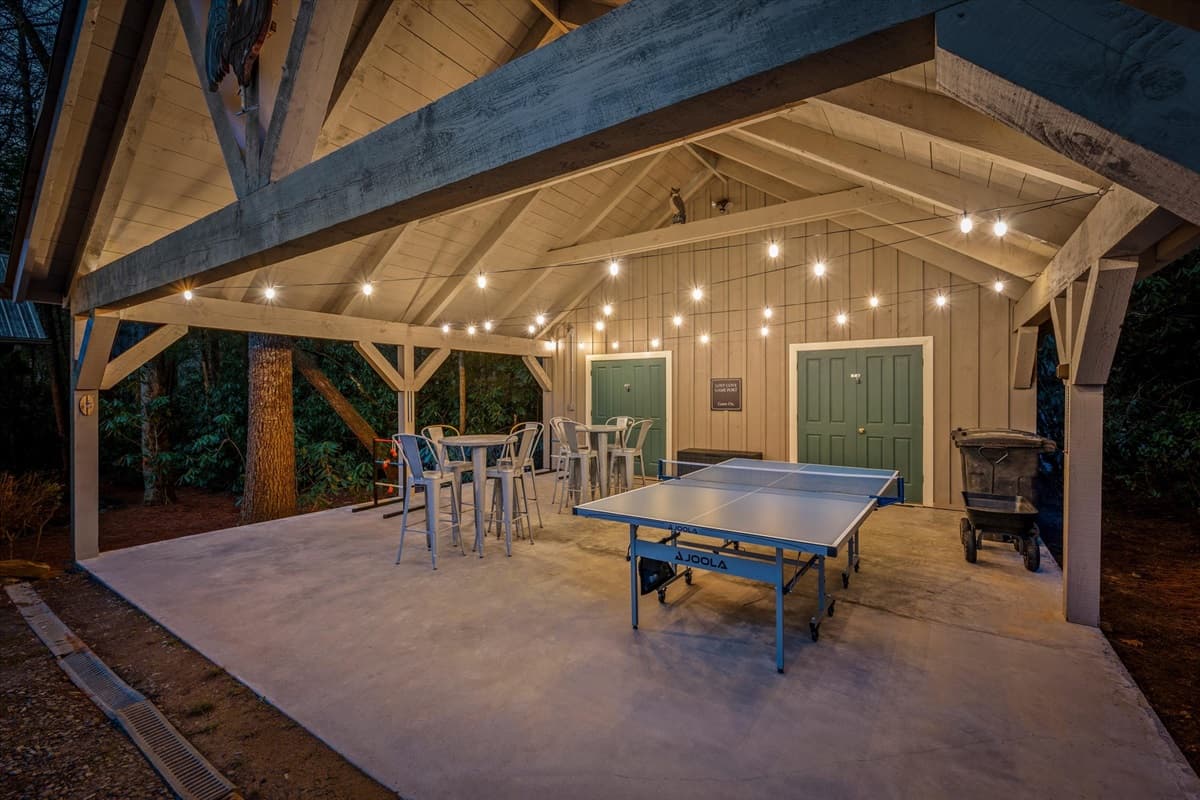 Enjoy our new game area in the carport featuring ping pong, outdoor jenga, hillbilly golf, string lights, and more.