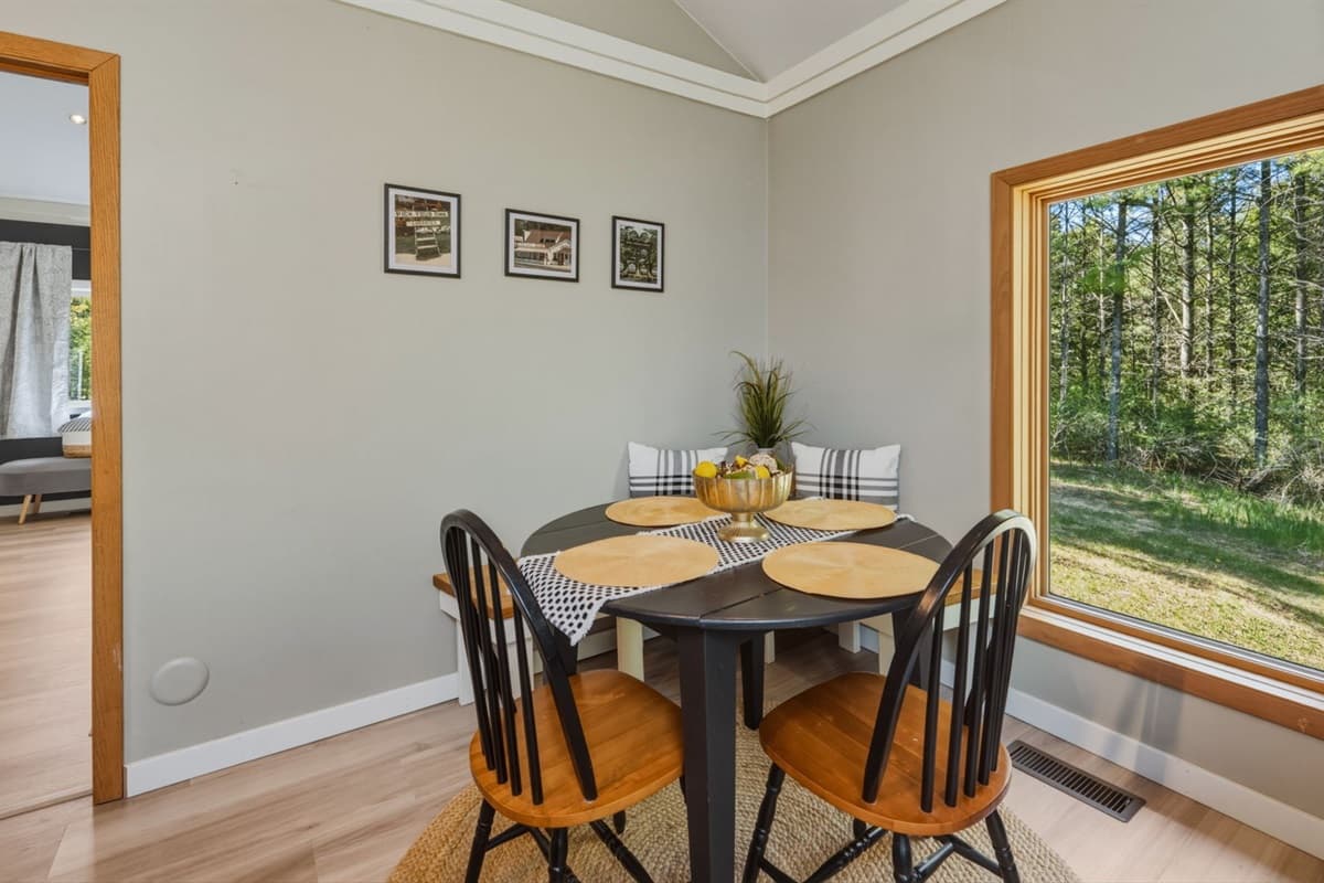 Dining area tucked into a cozy corner, featuring a built-in bench for comfortable seating and additional chairs for flexible group dining.