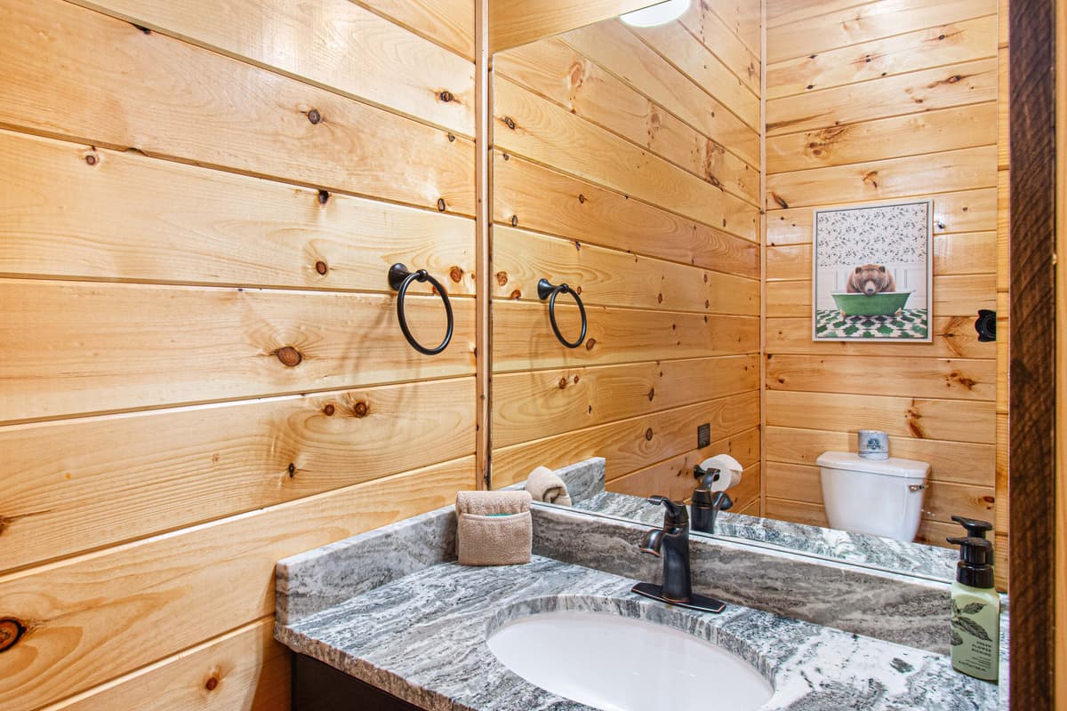 The convenient half bathroom provides an additional space for guests to freshen up during their stay