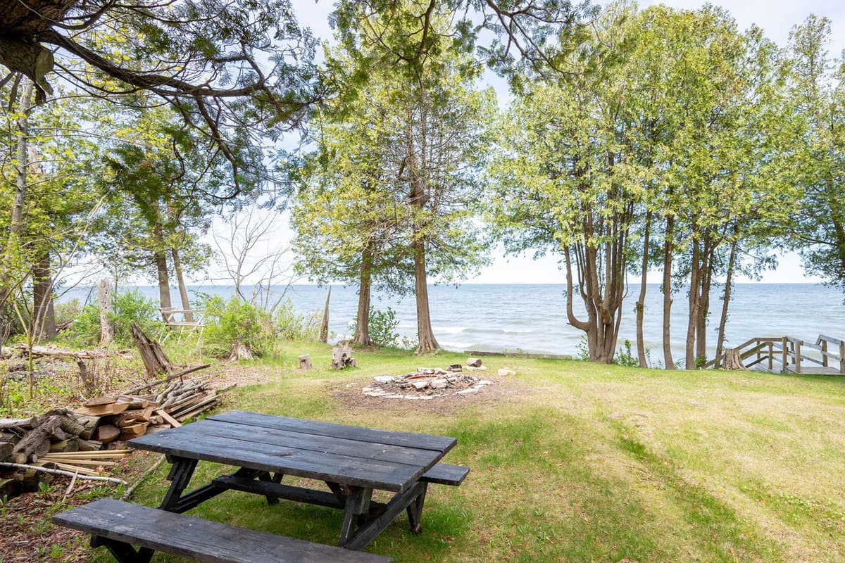 Relax by the lake at the outdoor picnic table, where beautiful waterfront views create a peaceful setting.