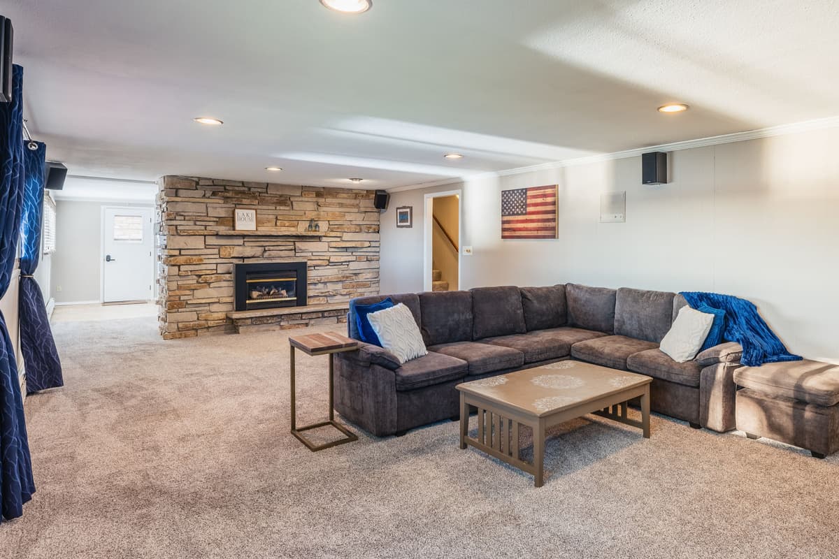 The lower living room offers a spacious and comfortable place to gather with family and friends.