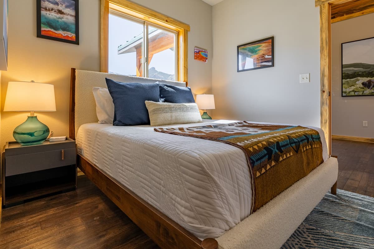 Wake up refreshed in a cozy queen bedroom with beautiful views of the Wyoming landscape.