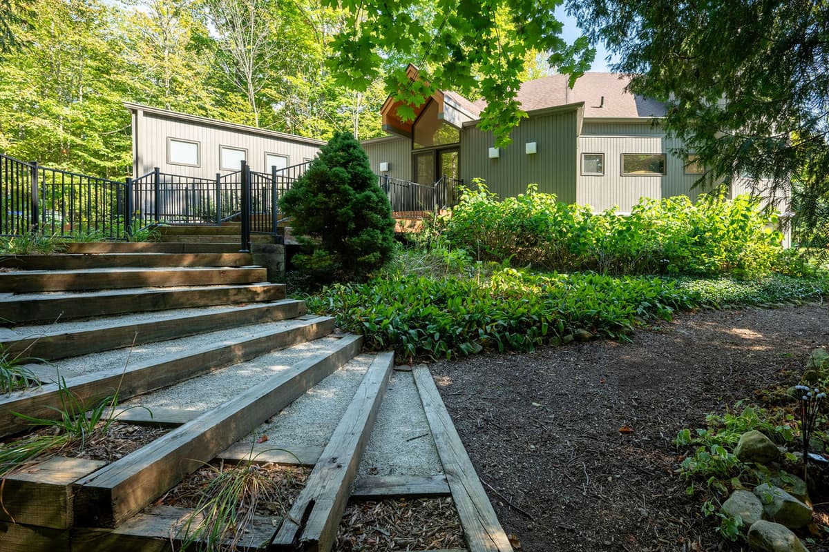 Nestled in a peaceful setting surrounded by lush greenery, this Sister Bay home offers a relaxing escape.