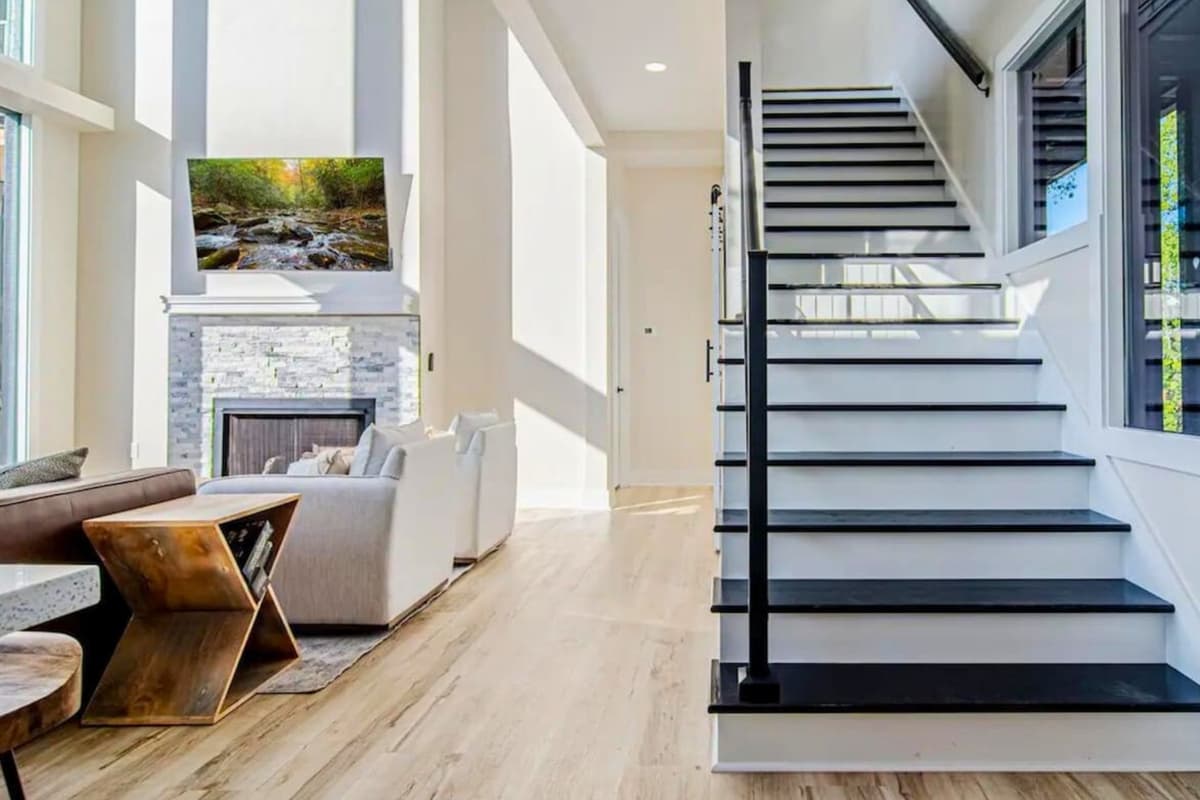 Back in the main living space, you’ll find the stairs leading upstairs to the bedrooms and additional areas of the home.