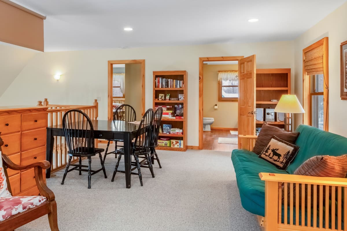 Upstairs, you’ll find a cozy mini living room with a comfortable sofa, tables, and chairs.