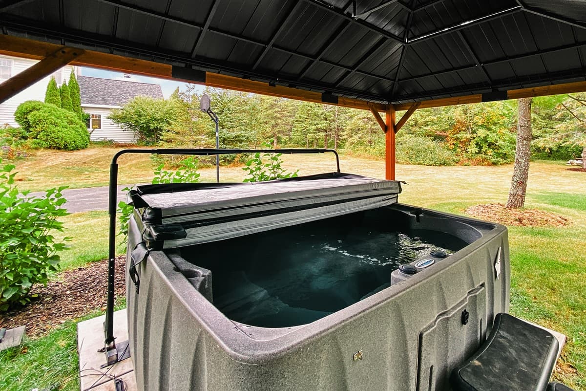 The combination of the hot tub and gazebo creates a perfect, tranquil escape.