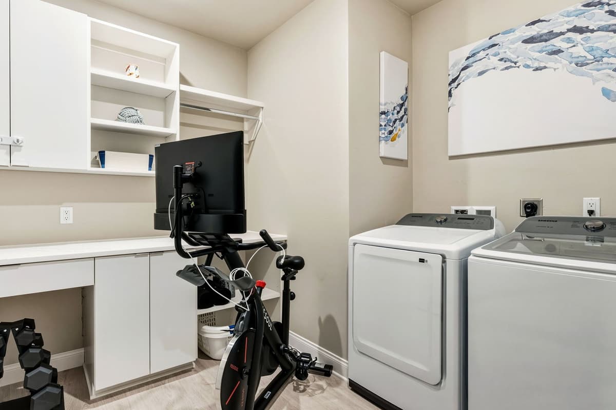 This convenient laundry room features a washer and dryer along with an exercise bike for added convenience during your stay.