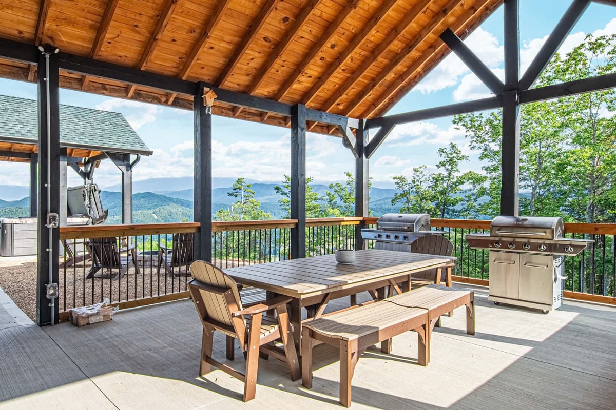 The covered space features a dining area where guests can gather for meals, along with a grill for preparing delicious outdoor favorites.