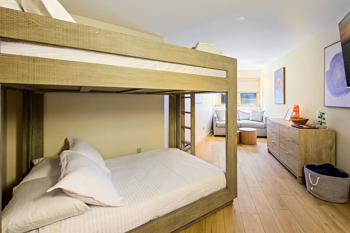 This spacious bedroom features a full-over-full bunk bed plus a comfortable sleeper sofa.