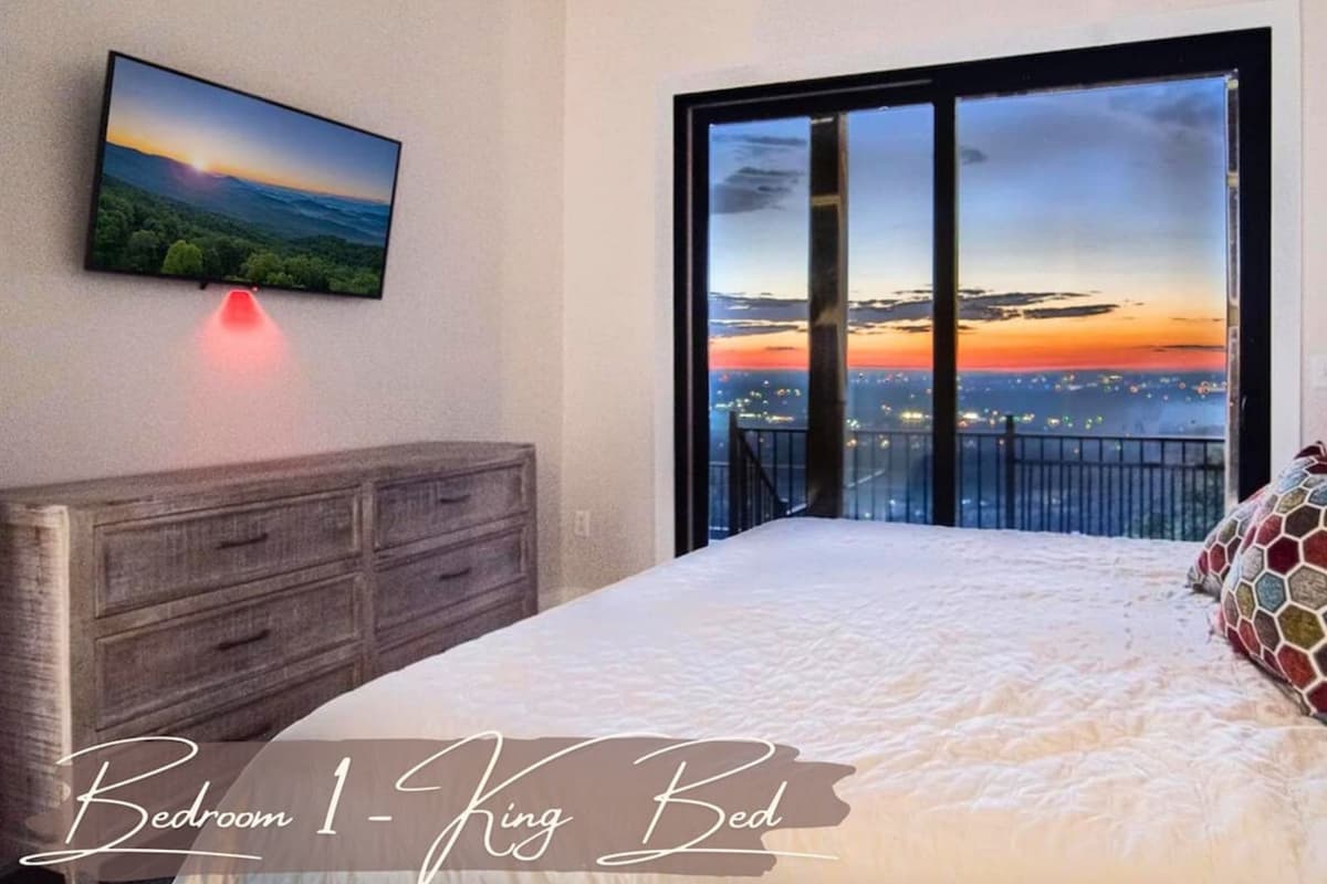 Retreat to the spacious king bedroom, featuring large glass doors that bring in plenty of natural light.