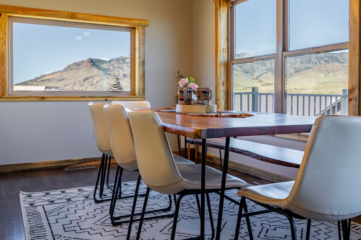The inviting dining area offers a comfortable space to share good food, stories, and laughter. Large windows bring in natural light and let you enjoy the beautiful Wyoming scenery while you dine.