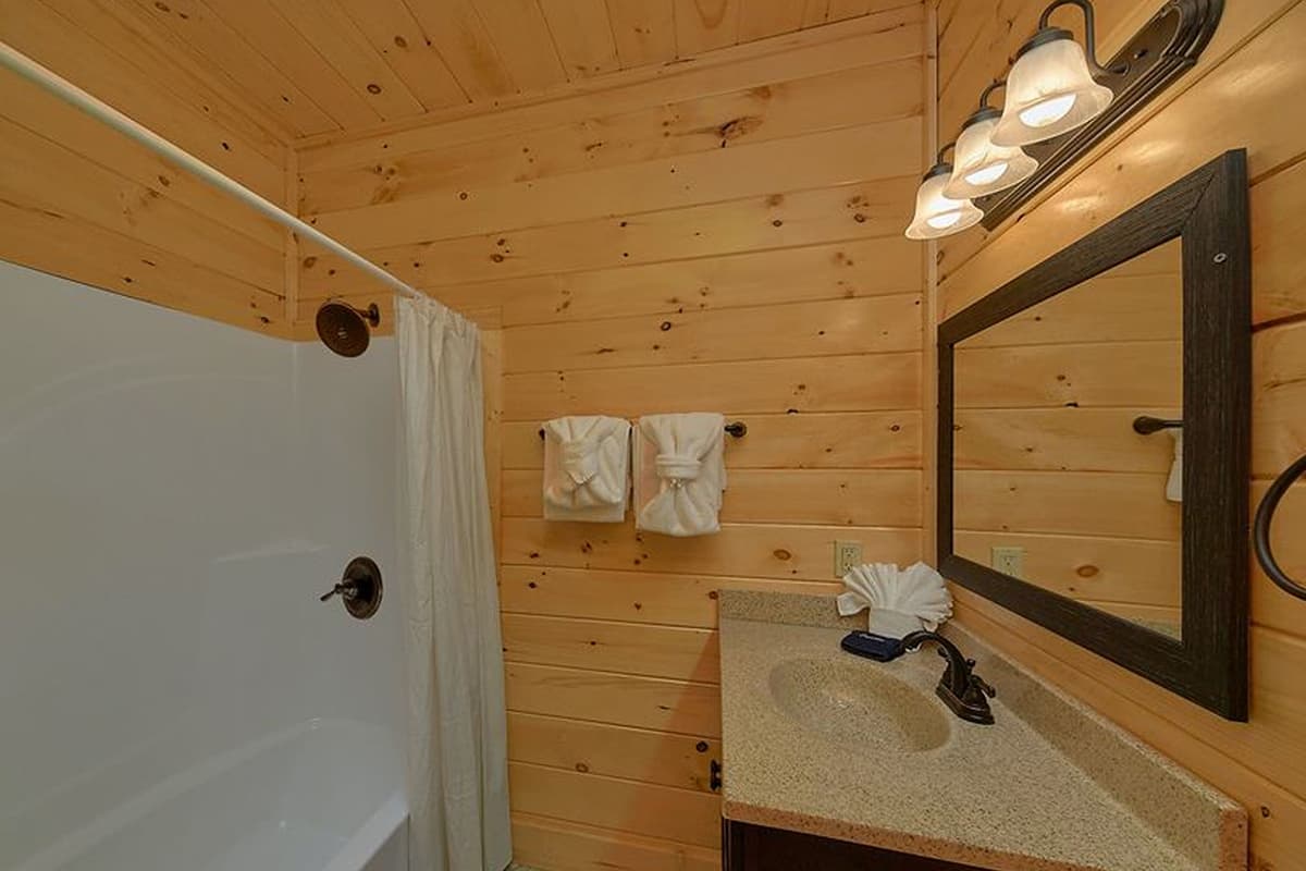 Freshen up with ease in this inviting bathroom, offering comfort and convenience throughout your cabin stay.