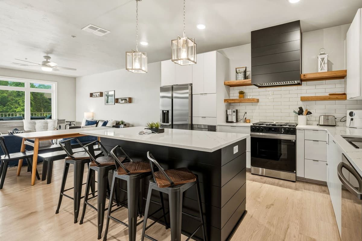 Right next to it, the kitchen features a convenient island with comfortable bar seating.