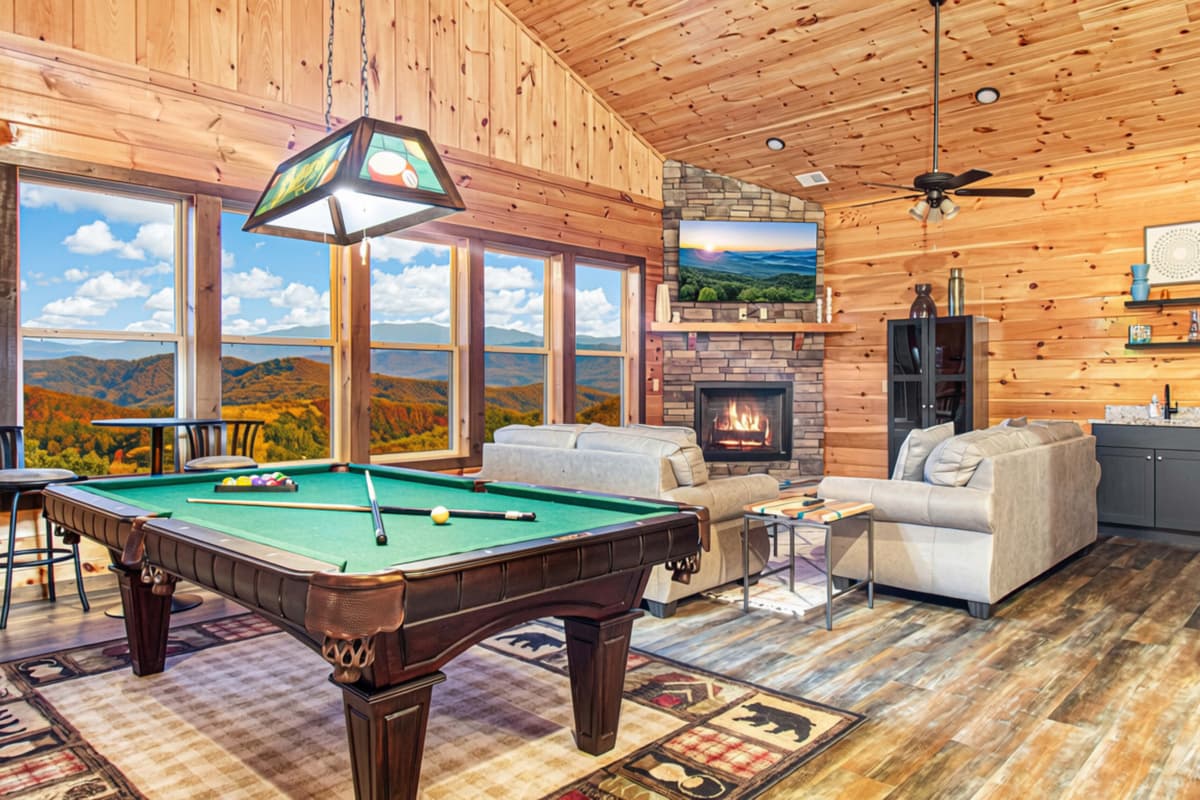 The living area features huge windows that bring the beauty of fall right indoors.