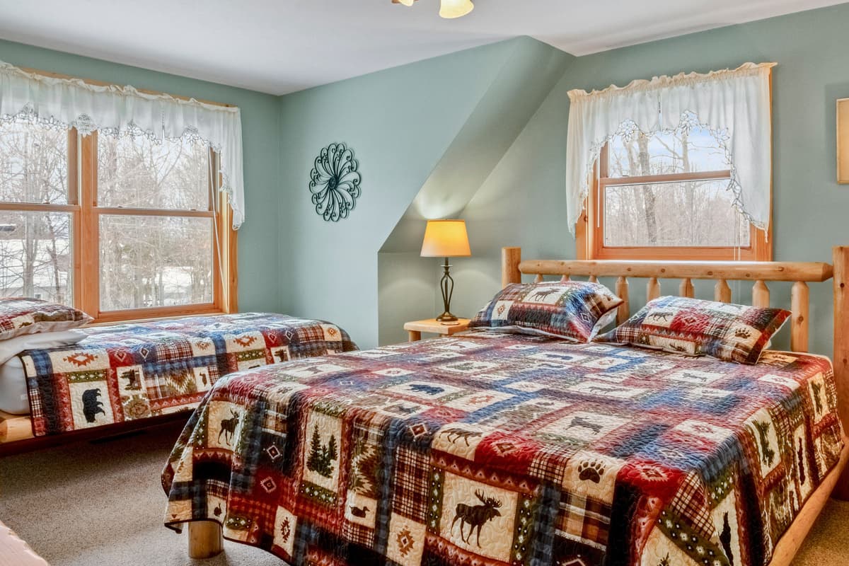 The upstairs bedroom offers a comfortable king bed along with a twin bed, making it a versatile space for families or groups traveling together.