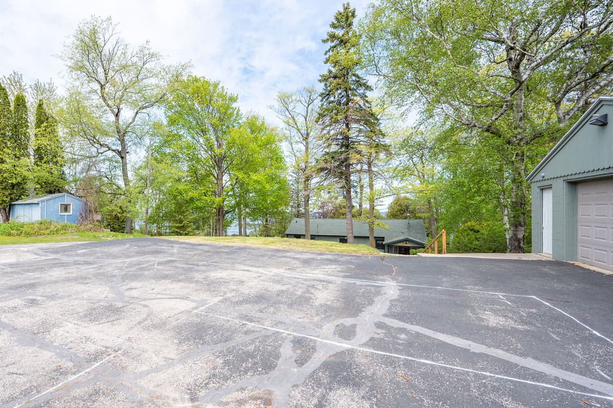 A convenient parking area is located directly in front of the garage, providing easy access to the home.