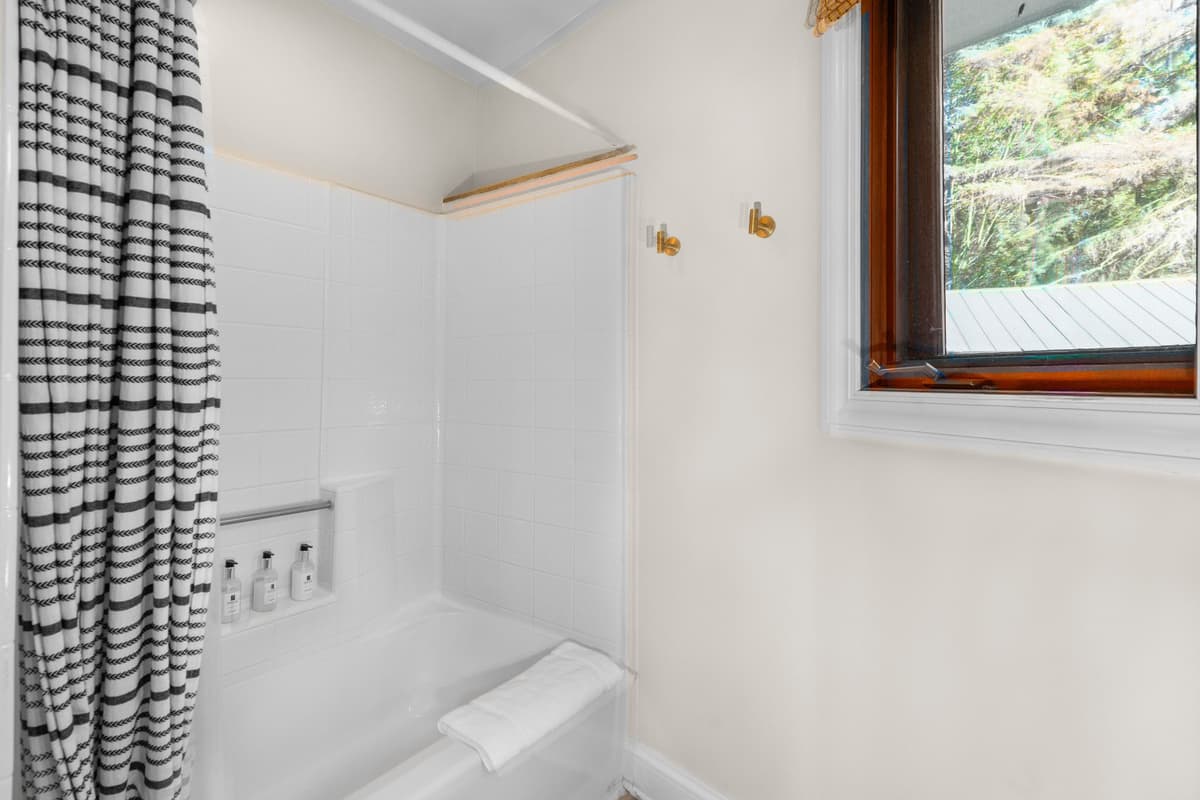 The bathroom features a combination tub and walk-in shower for flexible bathing options.
