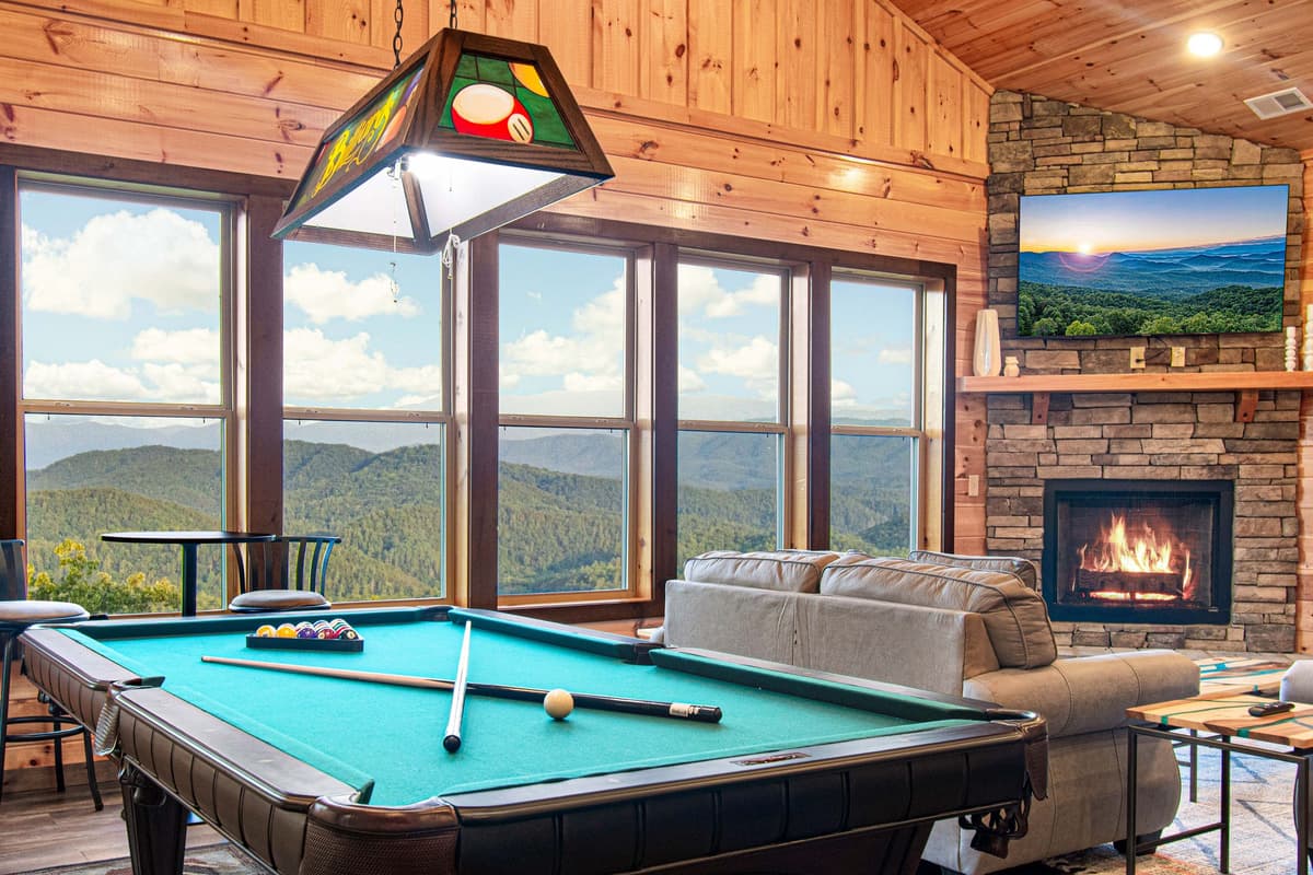 The room features comfortable seating and a pool table, making it a fun gathering spot for families and groups.