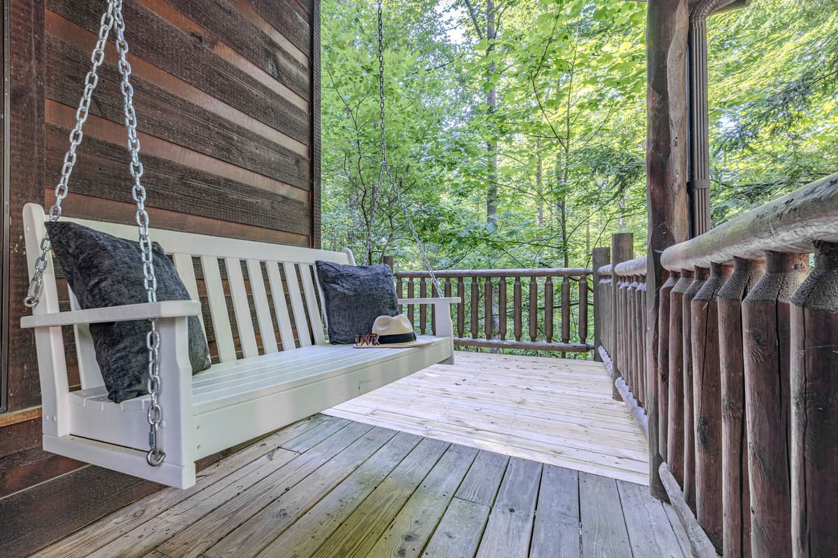 Step out onto the inviting covered porch and unwind on the comfortable swing, a perfect spot to enjoy your morning coffee or simply take in the serene wooded environment.