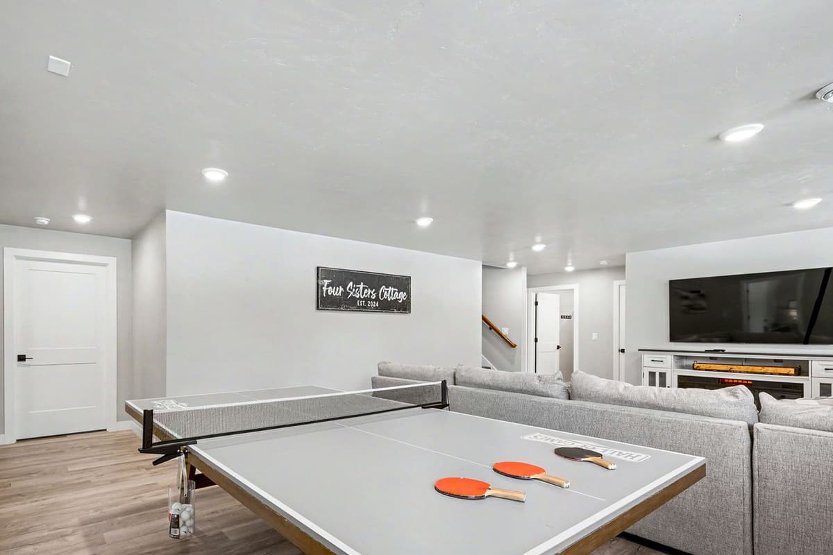 Have some fun and unwind in the inviting entertainment room, complete with a cozy plush sofa and ping-pong table.