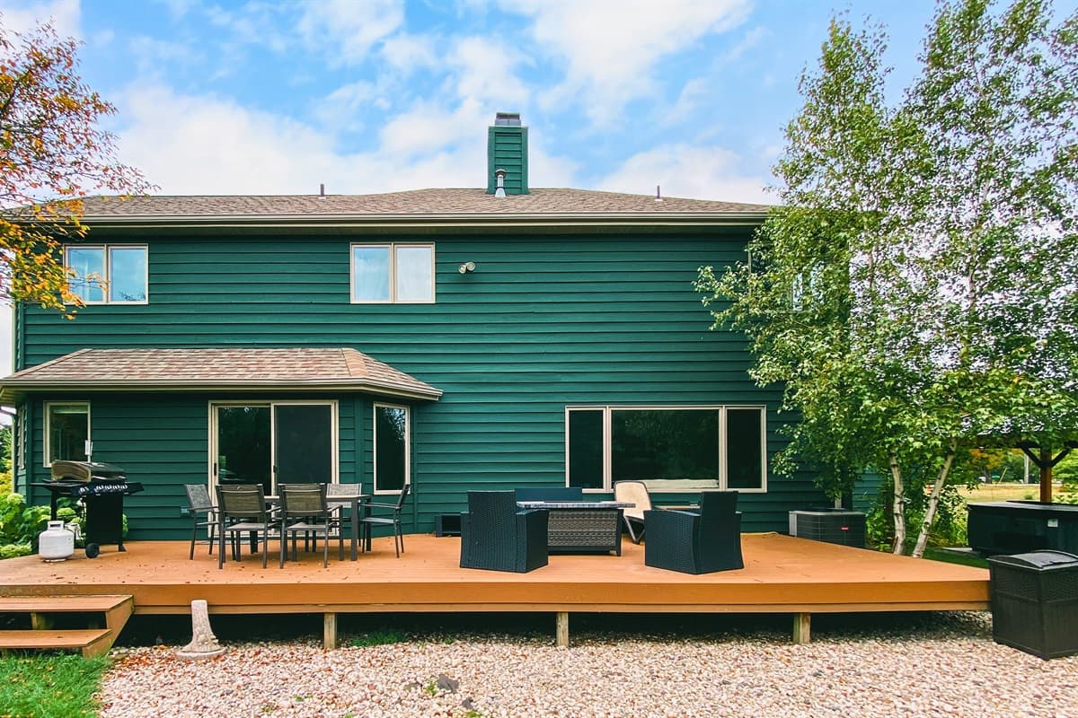 Step out onto the spacious outdoor patio deck at the back, where you can enjoy the beautiful surroundings.