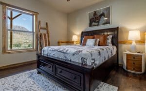 This queen bedroom offers not only spacious comfort but also spectacular views that invite the beauty of nature inside.