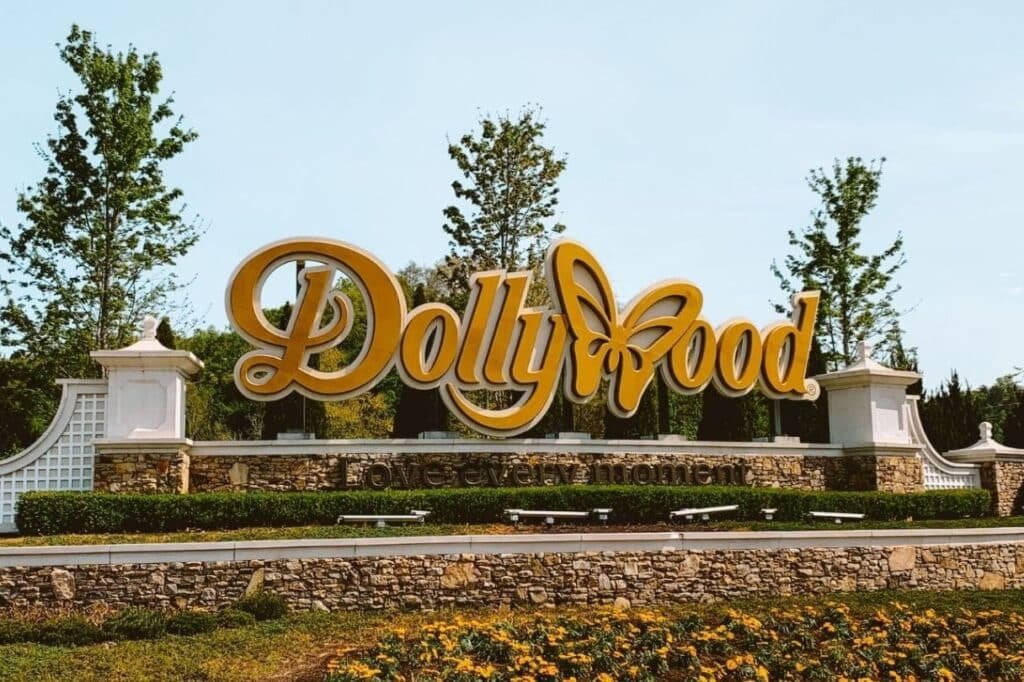 Guests riding a roller coaster at Dollywood with Smoky Mountains views in the background