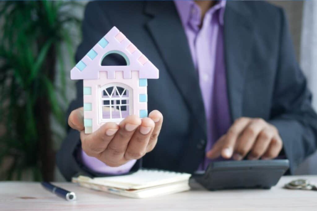 Vacation rental owners meeting with a property management team at a table reviewing plans