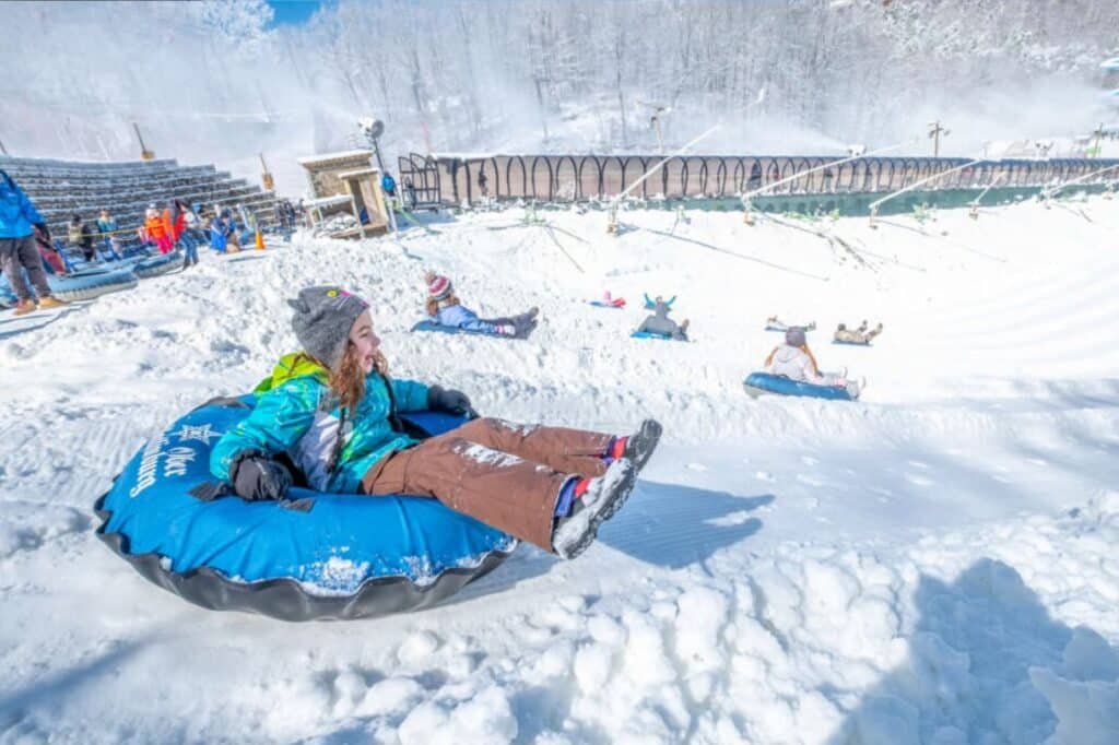 Children playing in the snow with the Smoky Mountains in the background