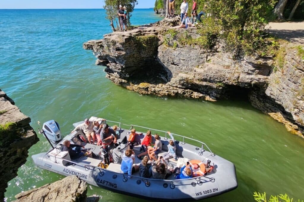 Small motorboat heading out from a Door County marina on a calm sunny day