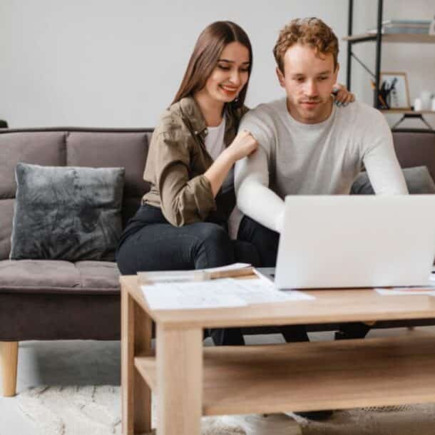 Vacation rental owner meeting with a property manager at a table reviewing documents