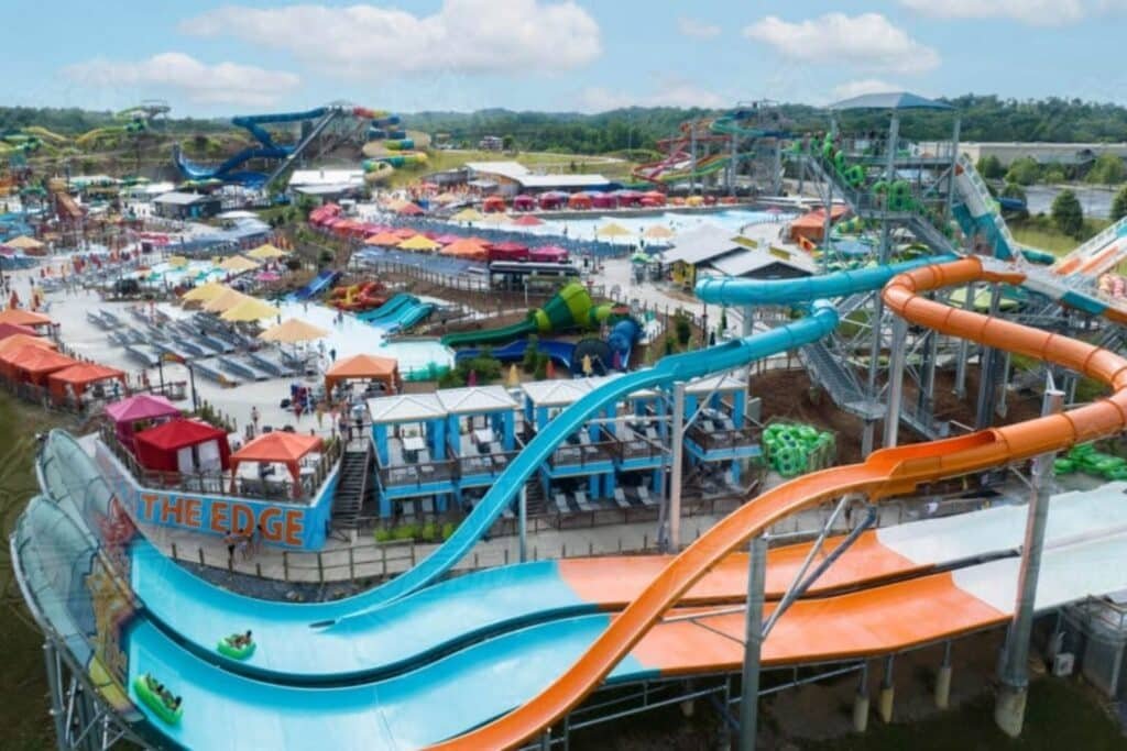 Guests riding water slides and floating in the wave pool at Soaky Mountain Waterpark