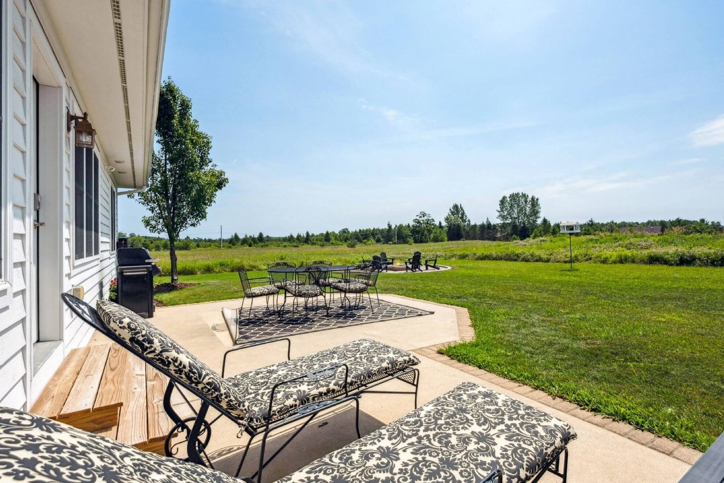 Outdoor living with dining space and loungers.