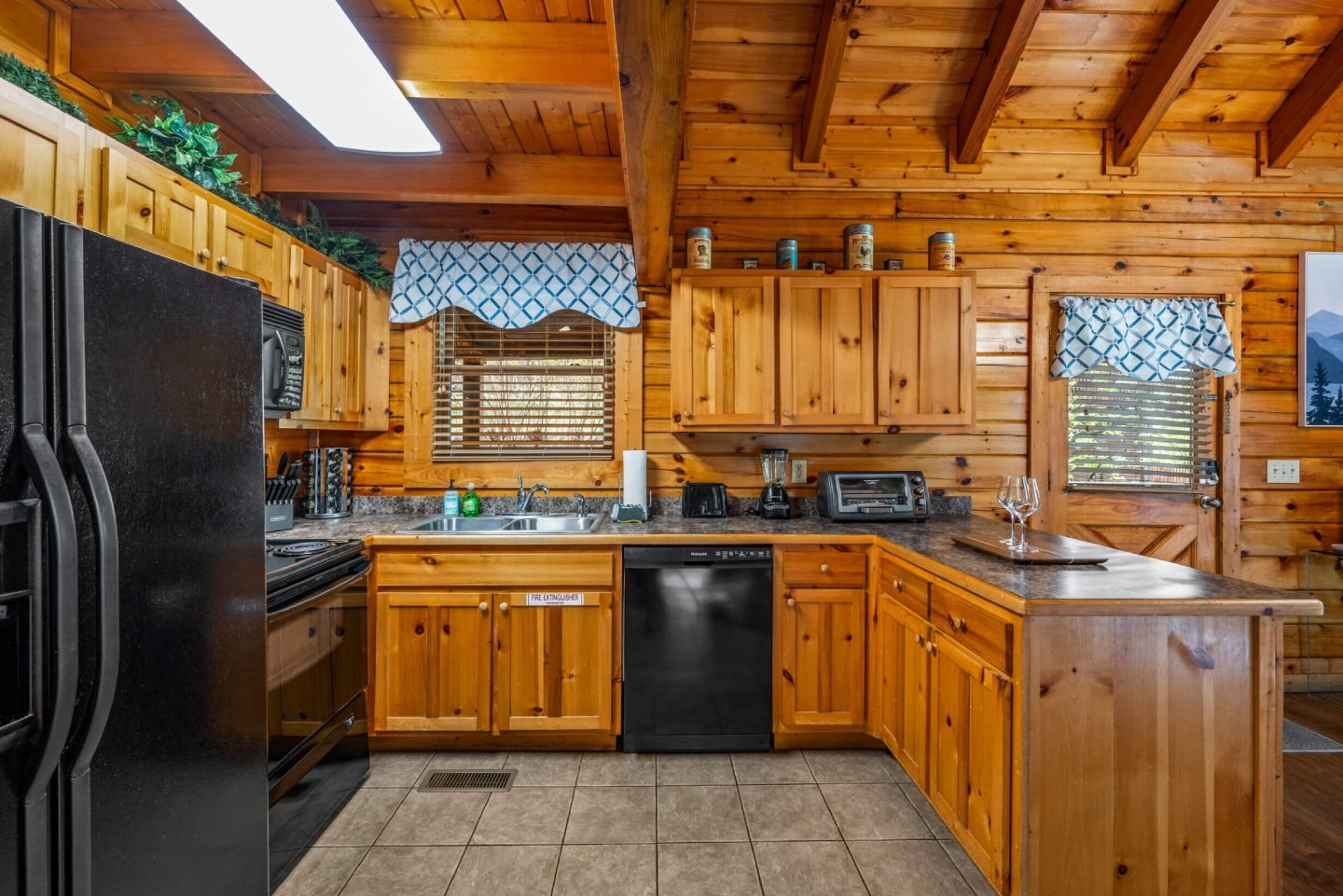 This inviting cabin retreat boasts a fully equipped kitchen and a spacious dining area with scenic views, creating the perfect setting for memorable meals and gatherings.