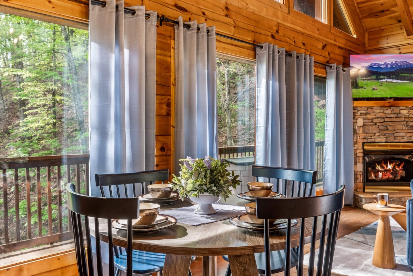 This stunning main living space, with its integrated kitchen and dining, features a cozy fireplace and vaulted wooden ceilings, offering a grand yet inviting atmosphere for all your group's activities.