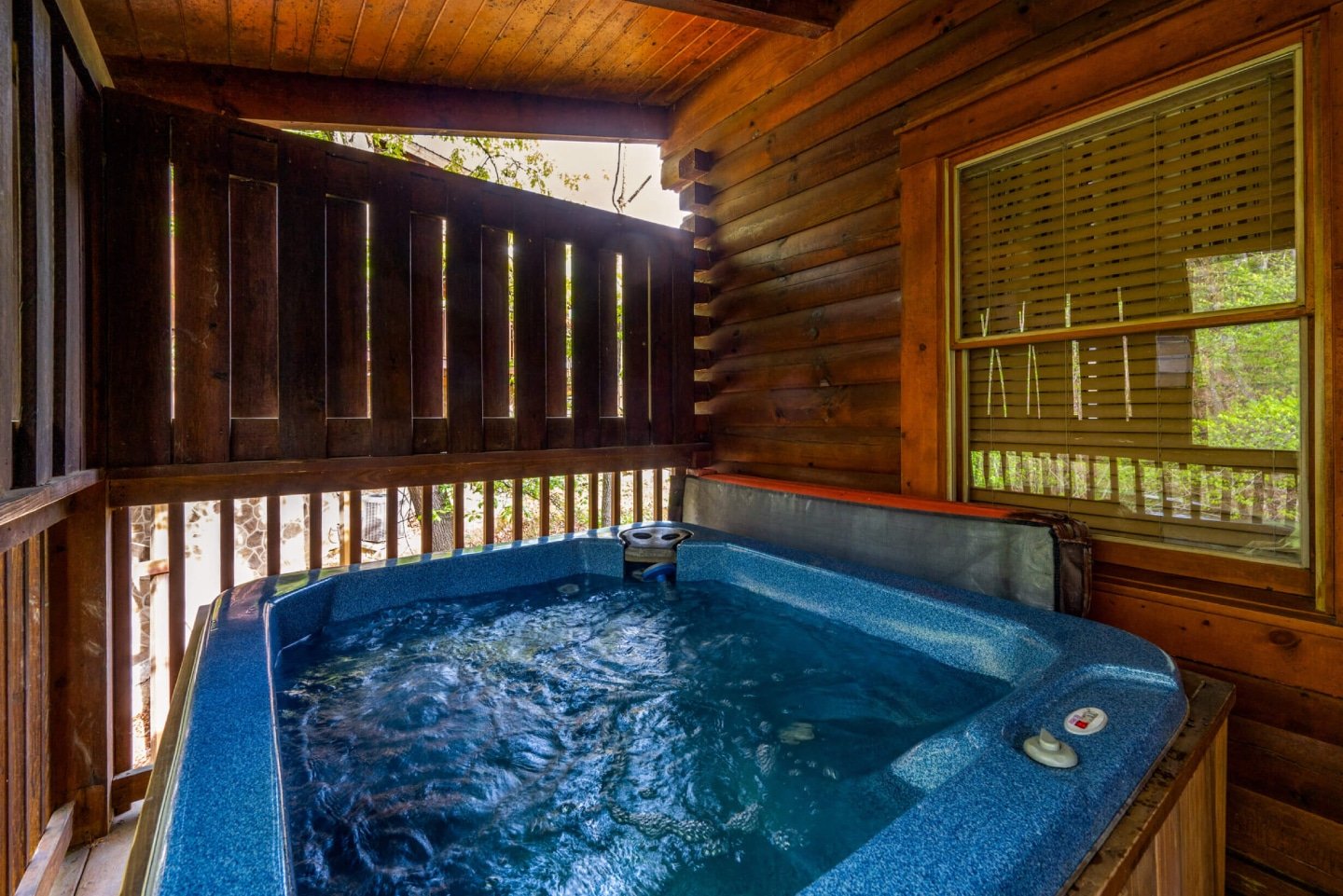 Imagine sinking into the warm, bubbling waters of your private hot tub, nestled on the expansive deck of your cozy cabin. As you relax, take in the breathtaking views of the lush, tree-filled hillsides. It's the perfect way to unwind and create unforgettab